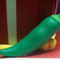 Green Chili 4 of 5: Closeup of a green chili made of modeling paste. As requested by birthday boy it has chili powder kneaded into it. That is the...