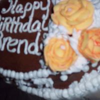 Brenda's Birthday Cake Oval Shaped Birthday cake made for my Sister N Law. Yellow butter cake with milk chocolate butter cream icing. Decorations are white butter...