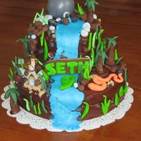 Indiana Jones Plastic Indy & boulder. Fondant for other pieces like rocks & trees, snake.