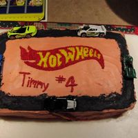 Hot Wheels hot wheels logo created by printing out a picture, cutting it out and tracing into the icing with a toothpick, then filling with stars.