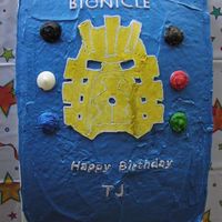 Bionicle Mask Of Light mask of light made in royal icing, colored dots are iced candy melts. The dark streak on the transfer was a patch job after breaking it...