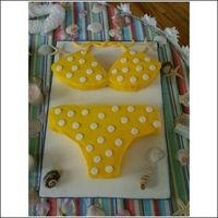 Yellow Polka Dot Bikini Coconut cream cake with buttercream icing. The polka dots and bikini strings were done in fondant....wish I had had the time to put a...