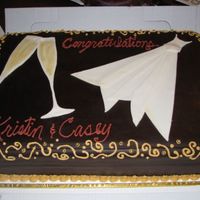 Dress And Champagne Glasses This was a 2 layer sheet cake covered in chocolate fondant. The cake was chocolate with a buttercream filling. The decorations were from...
