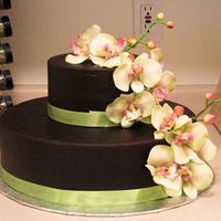 Chocolate Fondant This is covered in chocolate fondant with fake orchids placed in.