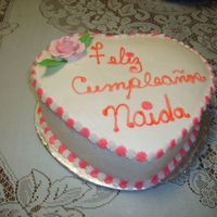 A Simple But Pretty Heart Shaped Cake This cake was vanilla and soaked in frangelico syrup. The frosting was flavored with almond and orange extract.