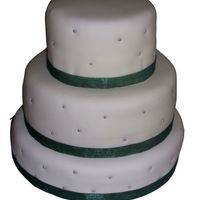 Mmf Wedding Cake 3 Tiered chocolate wedding cake iced in BC and covered in MMF. Silver sugar pearls added in and green ribbon around each base.