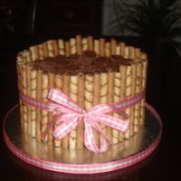 Peanut Buttercup, Chocolate Fudge, Gnache, And Cigarillo Cake chocolate fudge cake with fudge pudding and girhadelli's chocolate chips covered in chocolate gnache and decorated with alternating...