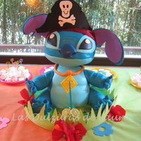 Stitch Carved chocolate cake, filled with dulce de leche and chocolate cream, covered in fondant. Head and arms are made of styrofoam, carved. TFL...