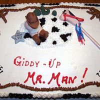 Cowboy Cake Decorated with buttercream icing. The baby, stick pony, and cacti are made from fondant.