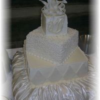 Wedding Cake With Fondant Bow This cake was white cake filled with bavarian cream, and smothered in buttercream. I used fondant for the accents and the bow. For the...