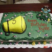 Cheerleader Cake Half Chocolate/Half Vanilla covered in BC. White chocolate cheerleader, royal icing drop flowers