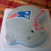 Football Helment This was my first try at a helmet cake. I took a large round pan and carved out the shape of the helmet. Cake is covered with buttercream...
