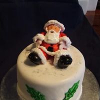 Santa this is the fourth of the mini christmas cakes i made for my mum, its fruit cake with fondant, santa is gumpaste with royal beard etc,...