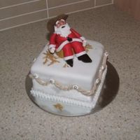 Cowboy Santa this is 3 of 4 christmas cakes i made for my mum, its 4" fruit cake with fondant, santa is gumpaste and he is sitting on a gumpaste...