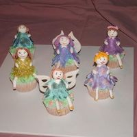 Fairy Cupcakes these are gumpaste fairys sitting on vanilla cupcakes... just made them for something to do...you cant see to well but they are all dusted...