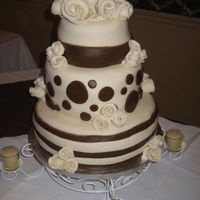 Wedding Cake A three tiered cream and brown round wedding cake I made for my friends wedding. Cakes covered in marshmallow fondant and all are fondant...