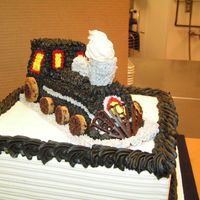 Train this was a Grooms cake to go with my Black & Silver wedding cake. Smoke is meringue on top of an upsidedown creme horn, everything is...