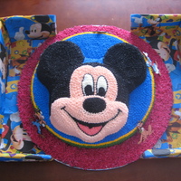 Mickey And Friends sponge cake covered with buttercream icing, the figures are sugarpaste, which I hand made as I could not find any figurines