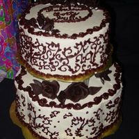 Scrollwork Cake Large chocolate mocha cake with chocolate mocha mousse filling. Small white chocolate cake with white chocolate raspberry filling. SMBC w/...