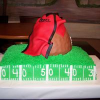Ocoee Bulldogs Pop Warner 9 X 13 sheet cake frosted in buttercream. 8 Cup measuring cup covered in fondant to look like a football and jersey out of fondant/gumpaste...