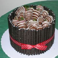 Strawberry Cake This is a vanilla cake with a brownie filling. It is iced in vanilla buttercream, surrounded by Oreo Fun Stix, and topped with chocolate...