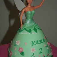 Tinkelrbell Doll Cake pouncake insite,covered and decoreted with marzefond.wings cut out of edible paper.flowers with differend cutters