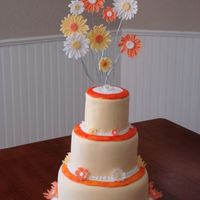 Yellow & Orange Daisy Cake This cake was for a multi-birthday celebration for my family. Lemon, white w/ strawberry, and white w/buttercream all covered with yellow...