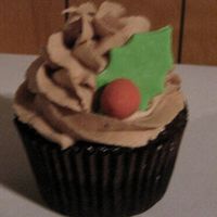 Christmas Cupcake! Chocolate with chocolate ganache filling, chocolate buttercream. Gumpaste holly berry and leaf.