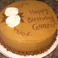 Birthday Cake! I made this for a friend/co-worker. Chocolate cake with vanilla buttercream. My camera's not all that great, so those two white orbs...