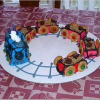 Train Individual cakes decorated with buttercream. Used crushed up cookies, wafers, kisses & M&Ms as accents.