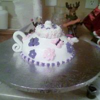 Teapot With Butterflies & Flowers Buttercream icing with fondant handle & spout.