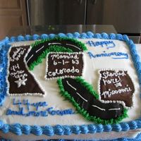 Anniversary yellow cake with rasberry filling and all buttercream. The states are done with melted chocolate.