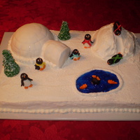 Penquin Vanilla cake and vanilla b/c icing with fondant penquins.Igloo is fondant covered and snow mound is b/c. Trees were ice cream cones coverd...