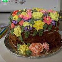 Course 2 This was my first attempt at RI.... and at basketweave. It is a white cake with BC icing and RI flowers