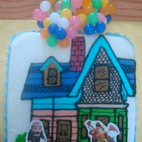 Up This is an 8 inch square cake othe the house drawn and colored in buttercream. the balloons and stickers were added.