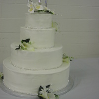 My Sister's Wedding Cake White almond sour cream cake with buttercream filling and icing. Gumpaste flowers on top.