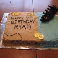 Pirate Birthday This is a devil's food cake with buttercream icing. The ship is a toy and the coins were party of a halloween costume.