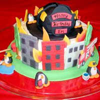 Penguin Firemen Cake My sister is a firefighter and loves penguins so this is her birthday cake. Helmet is rice crispies covered in fondant. Penguins and other...