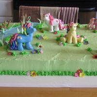 My Little Pony Half yellow, half chocolate cake with buttercream icing. Fondant ponies and decorations. Fun to make. I use to play with My Little Ponies...