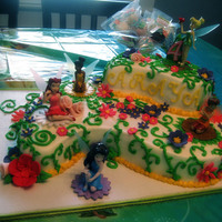 Araya's Fairies large and small paisley shapes...all buttercream w/ fondant flowers. (chocolate cake and spice cake)Figures are plastic.