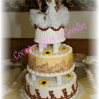 Western Wedding Cake This is a 3 layer white cake with buttercream icing. Top layer is 6", middle is 10", and bottom is 12". The middle was...