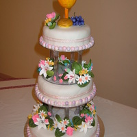 First Holy Communion Cake FRUIT CAKE DECORATED IN ROLLED FONDANT ICING WITH FLOWERS AND TOPPER IN GUM PASTE.