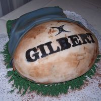 Muddy Rugby Game Ball Cake I made this to go along with the rugby shoes cake. I used two Wilton First and Ten football pans for the cake and "shaved" off...