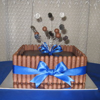 Chocolate 5 Cent Cake Choc mud cake covered in ganache with choc covered biscuit stcks around the sides. "bouncies" are malteasers threaded onto wire...