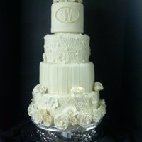 Ivory Wedding Cake Stacked tiers covered in Ivory Fondant with Ivory Gumpaste Roses.Cake was based on a Picture given by bride.