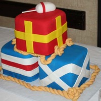 Nautical Flags This was for a wedding with a nautical theme. Each flag is 6x6x6 and covered in fondant and each represents a letter of the groom's...