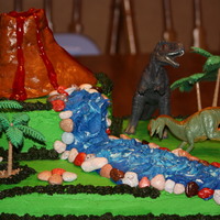 Dinosaur Cake Dinosaur cake made for a 5 year old for his birthday using his favorite dinosaurs. Volcano is MMF.