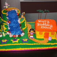 Dora The Explorer Cake Dora cake that I made for my daughter. Waterfall part is chocolate cake, rest is yellow cake with buttercream icing. Stars are MMF.