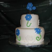 Blue Flowers White Chocolate cake with buttercream filling and fondant.