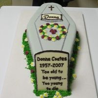 Coffin And Tombstone 50th birthday cake. Nameplate and tombstone made from chocolate. Mini buttercream roses.